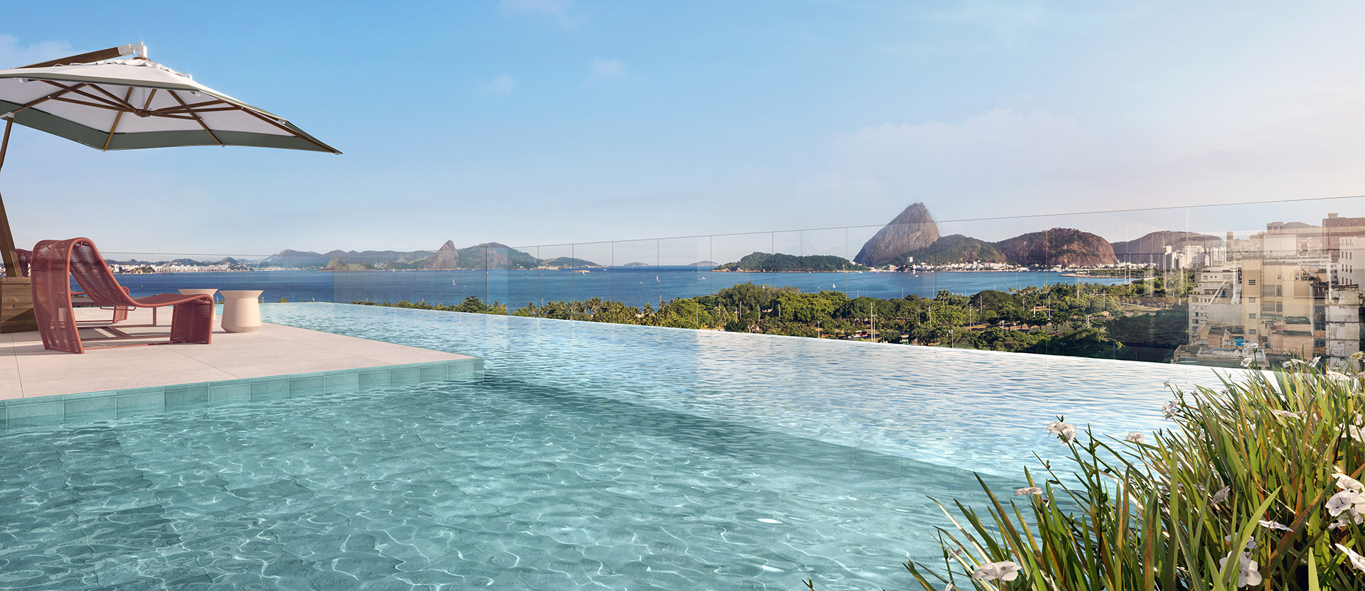 Perspectiva da piscina do rooftop, com o Parque do Flamengo e o Pão de Açúcar ao fundo